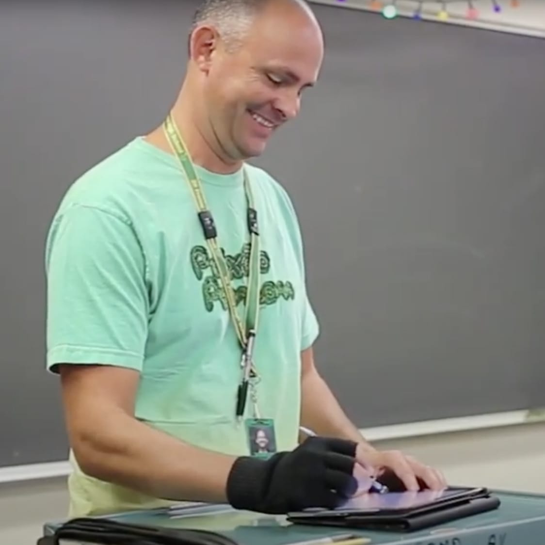 Photo of a teacher standing in front of their class